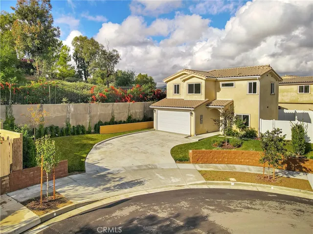 a front view of a house with a garden