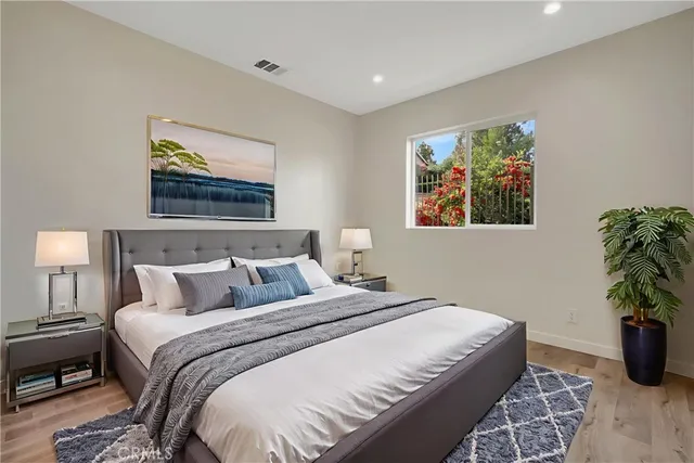 a bedroom with bed and wall painting