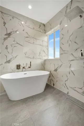 a white tub sitting in a bathroom