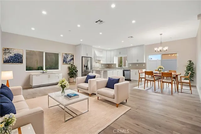 a living room with lots of furniture and kitchen view