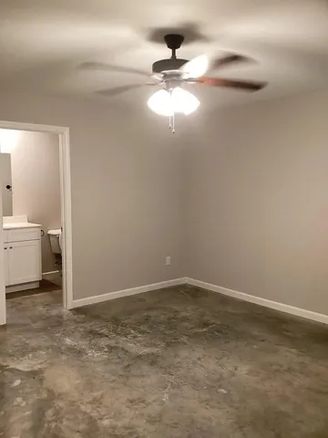 a view of a room with a sink and cabinets