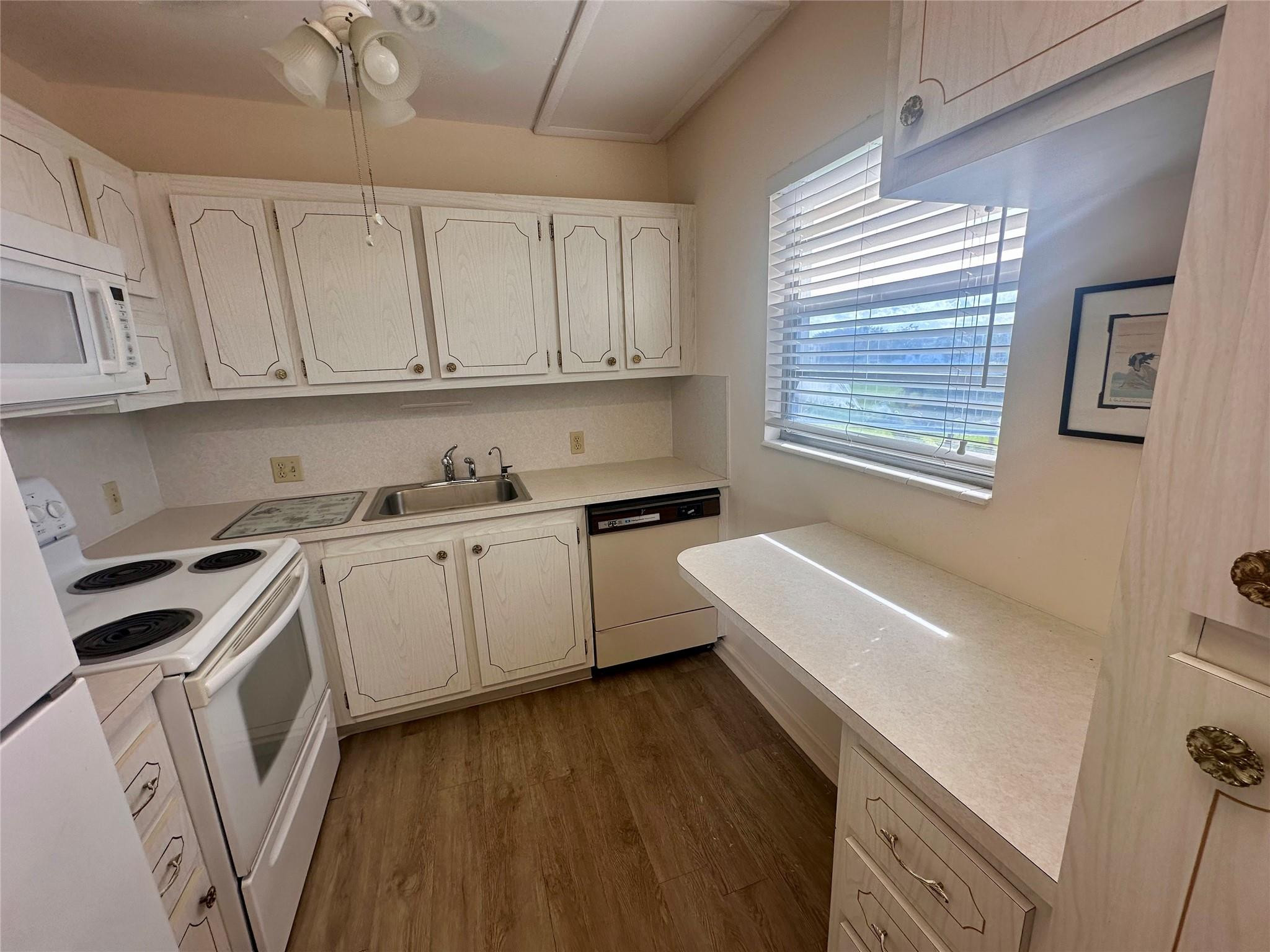 29 Preston A Boca Raton, FL 33434 - Photo 3 of 21 a kitchen with granite countertop white cabinets and white appliances