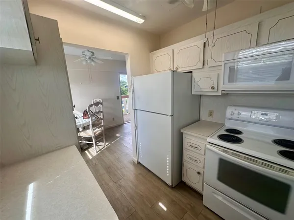 a kitchen with a refrigerator and a stove top oven