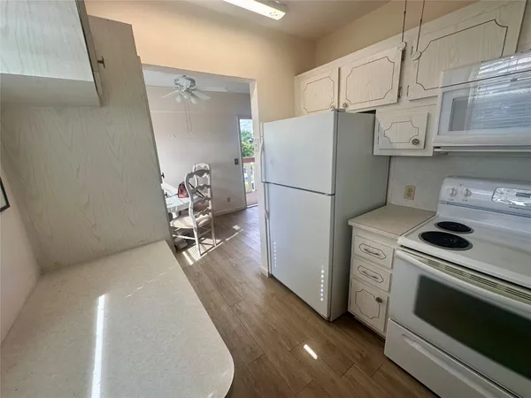 a kitchen with appliances a refrigerator and a stove top oven