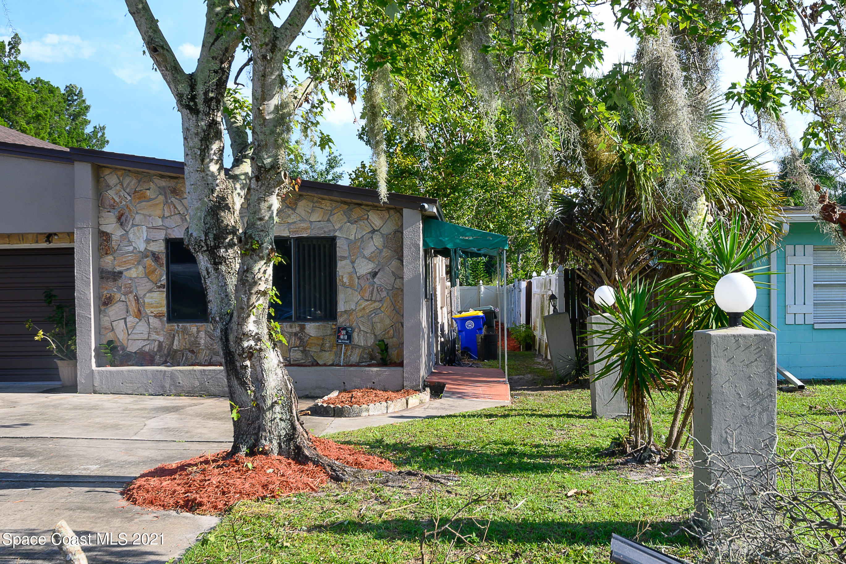 1003 Bernice Road Rockledge, FL 32955 - Photo 22 of 43 a front view of a house with garden