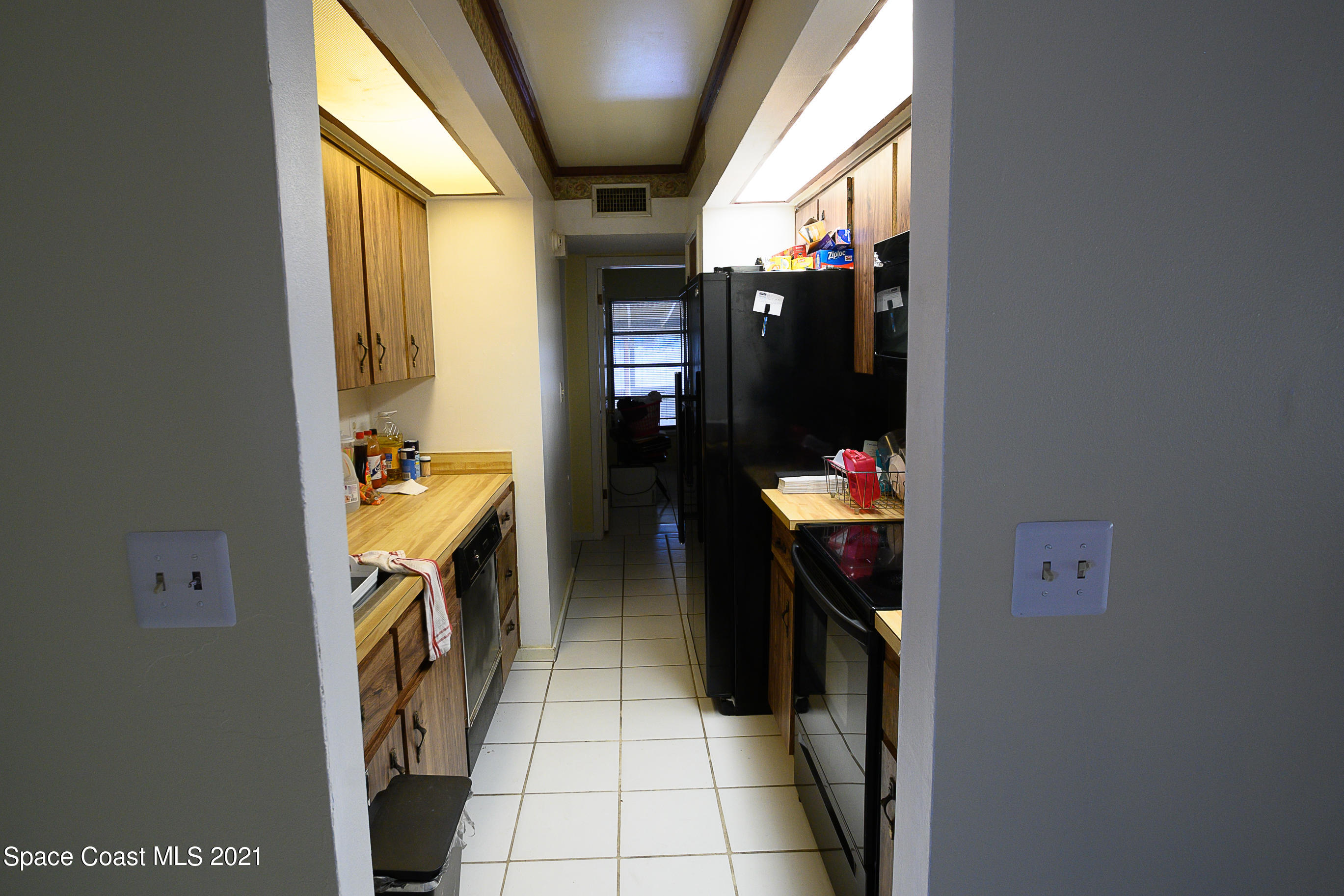 1003 Bernice Road Rockledge, FL 32955 - Photo 29 of 43 a hallway with a washer and dryer next to a window