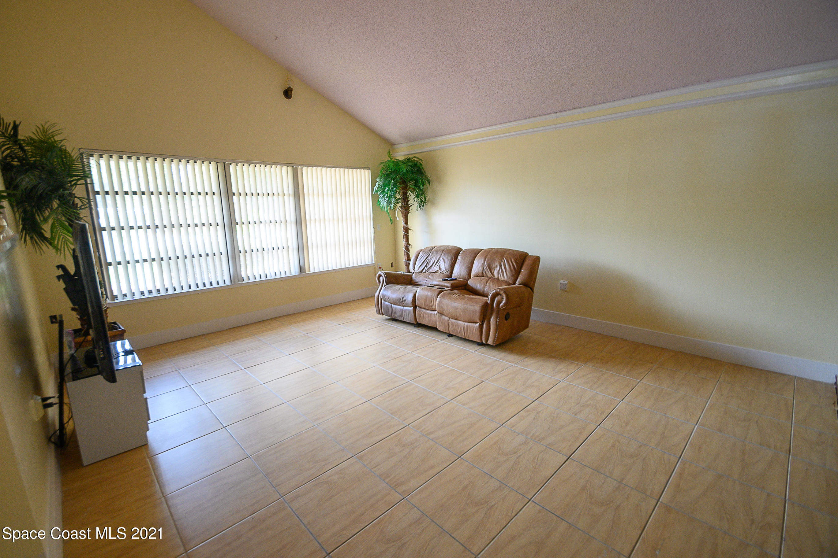 1003 Bernice Road Rockledge, FL 32955 - Photo 4 of 43 a living room with furniture and a floor to ceiling window