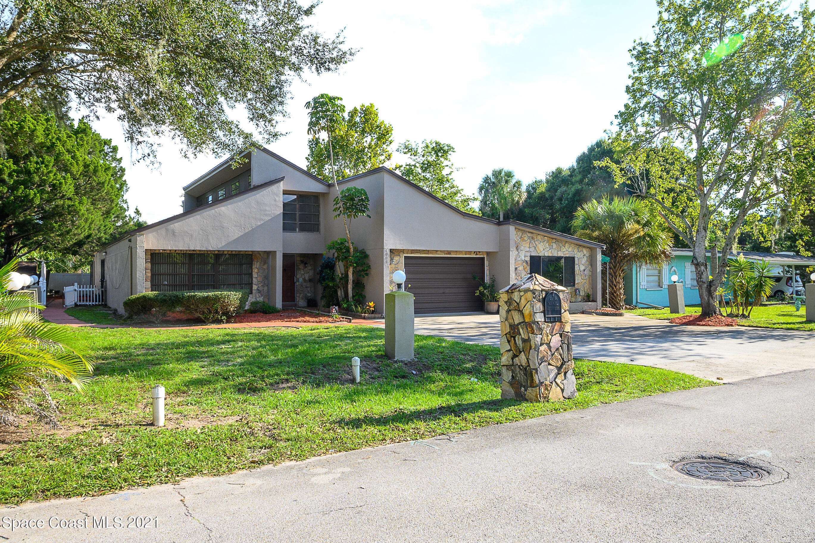 1003 Bernice Road Rockledge, FL 32955 - Photo 34 of 43 a front view of house with a garden and trees