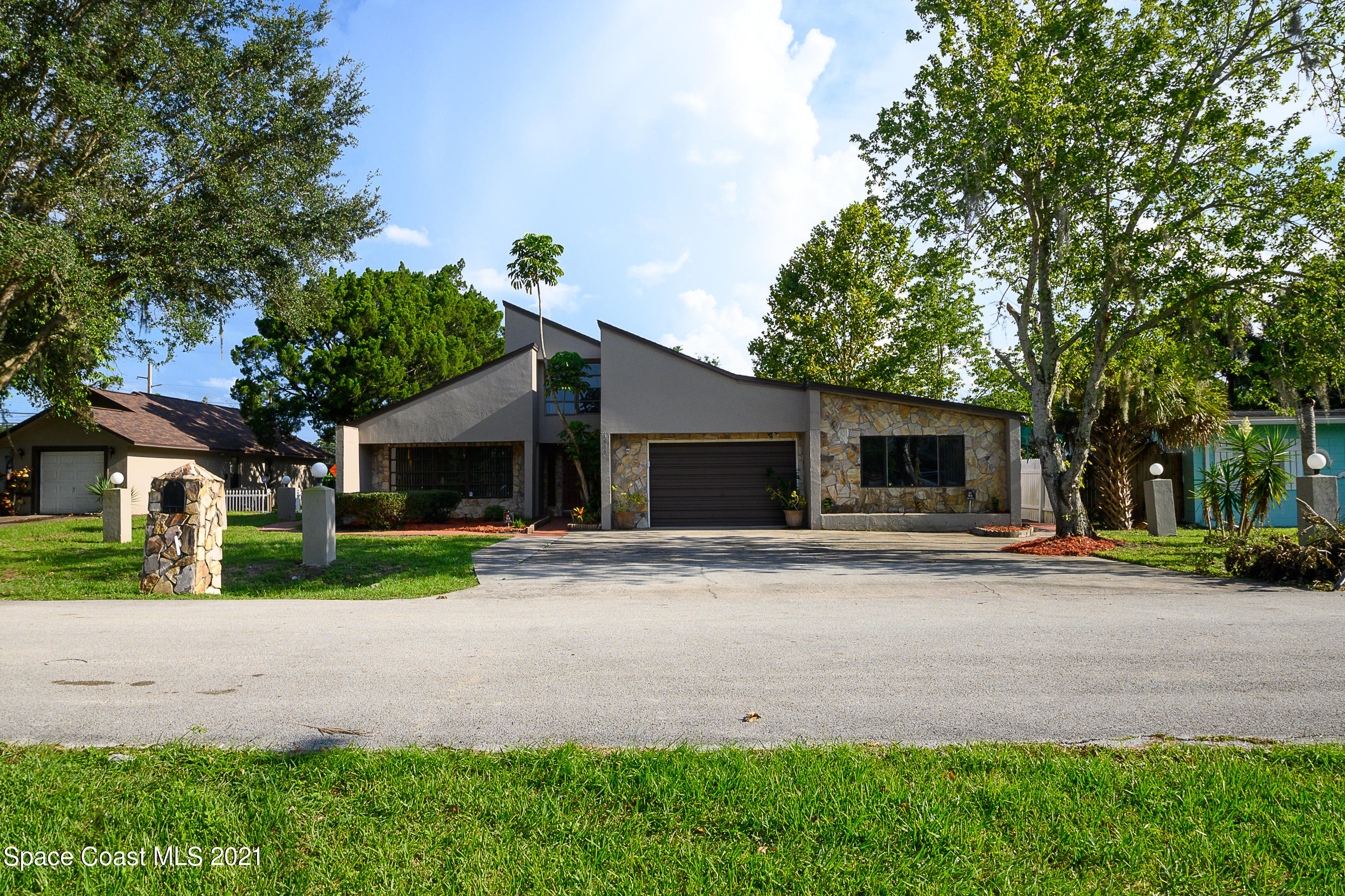1003 Bernice Road Rockledge, FL 32955 - Photo 36 of 43 a front view of a house with a yard and garage