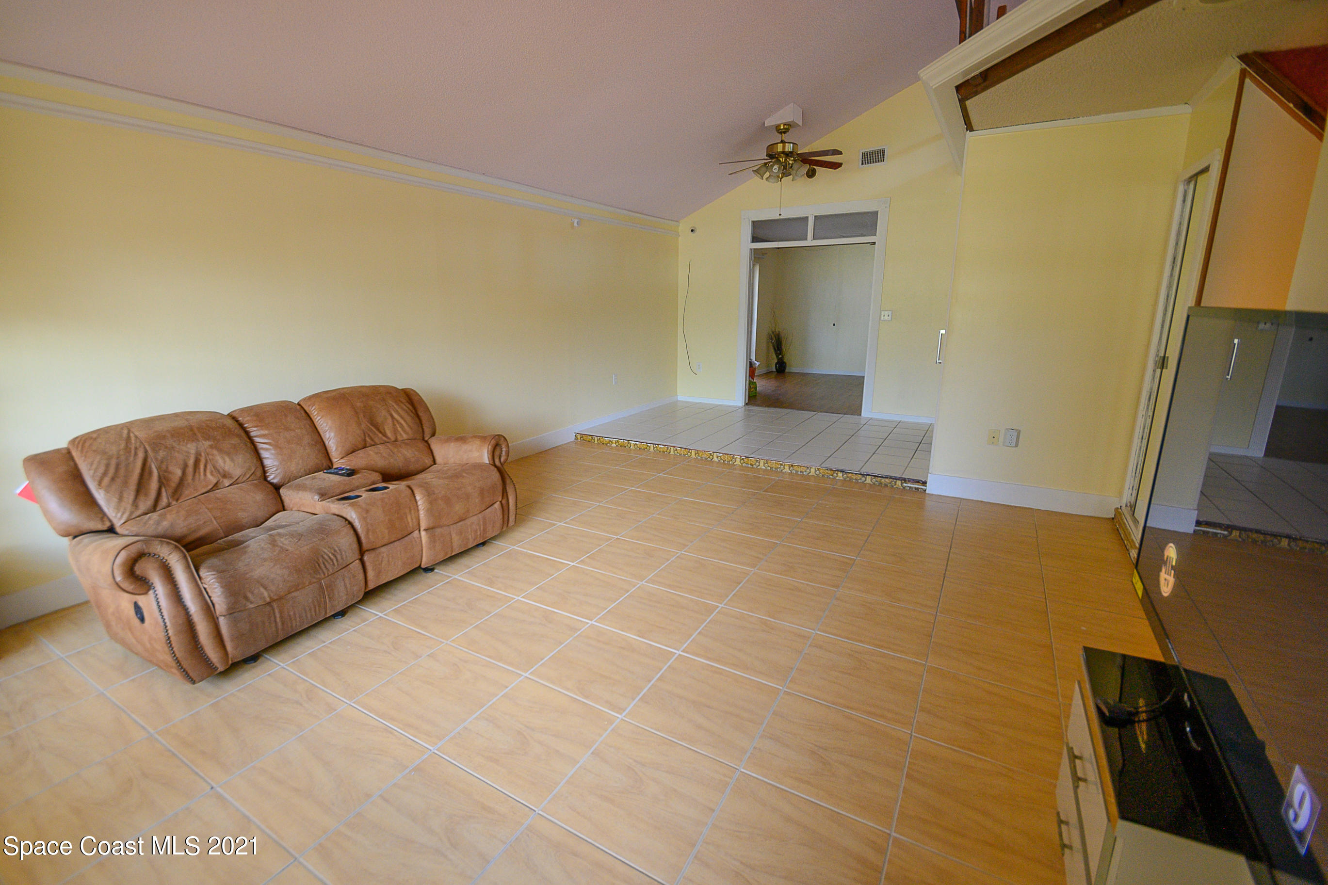 1003 Bernice Road Rockledge, FL 32955 - Photo 5 of 43 a living room with a couch and a stove next to a window