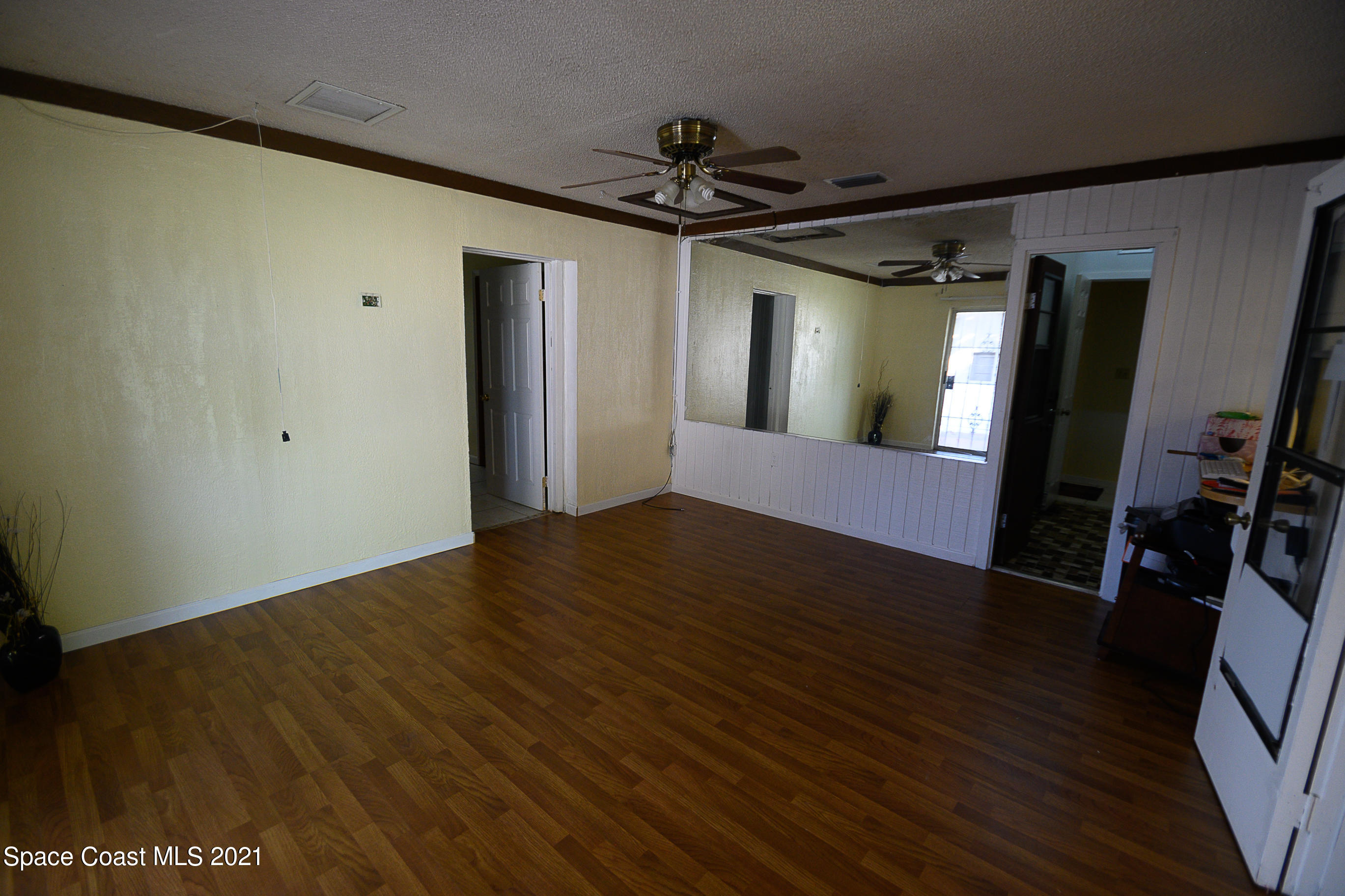 1003 Bernice Road Rockledge, FL 32955 - Photo 7 of 43 a view of a hallway with wooden floor and staircase