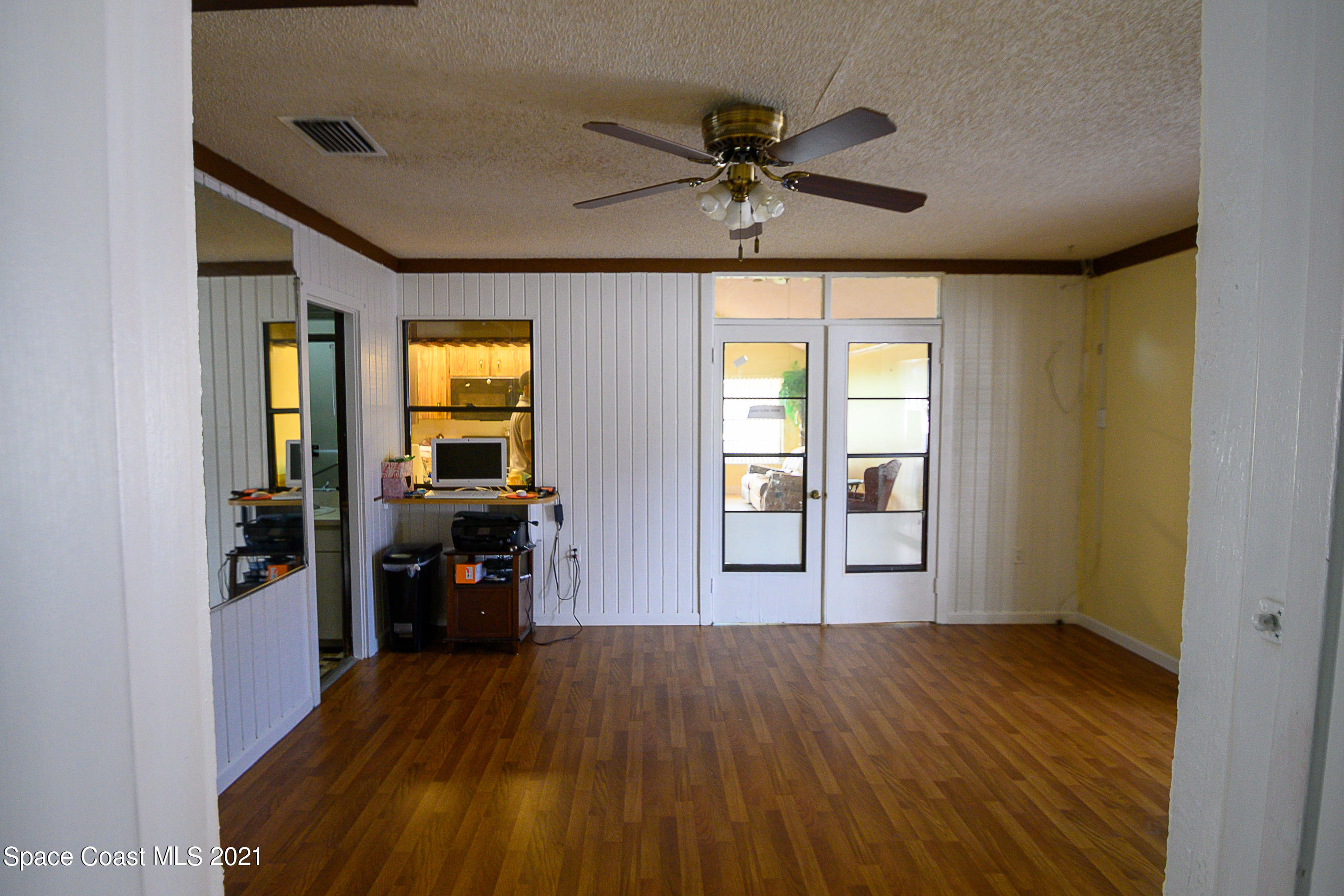 1003 Bernice Road Rockledge, FL 32955 - Photo 8 of 43 a view of a livingroom with a furniture hardwood floor and a ceiling fan