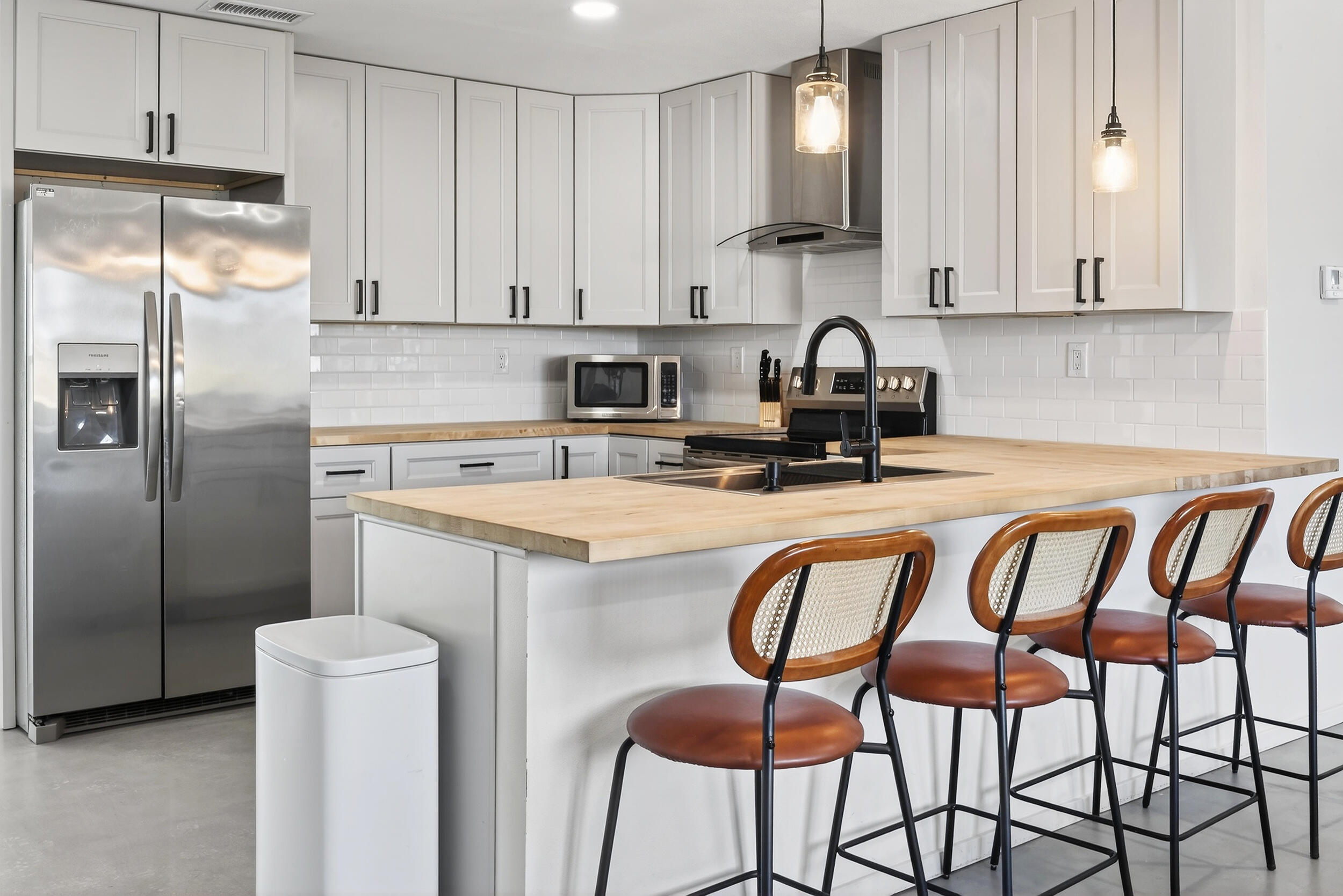 2071 Border Avenue Joshua Tree, CA 92252 - Photo 12 of 50 a kitchen with stainless steel appliances granite countertop a refrigerator and a stove top oven