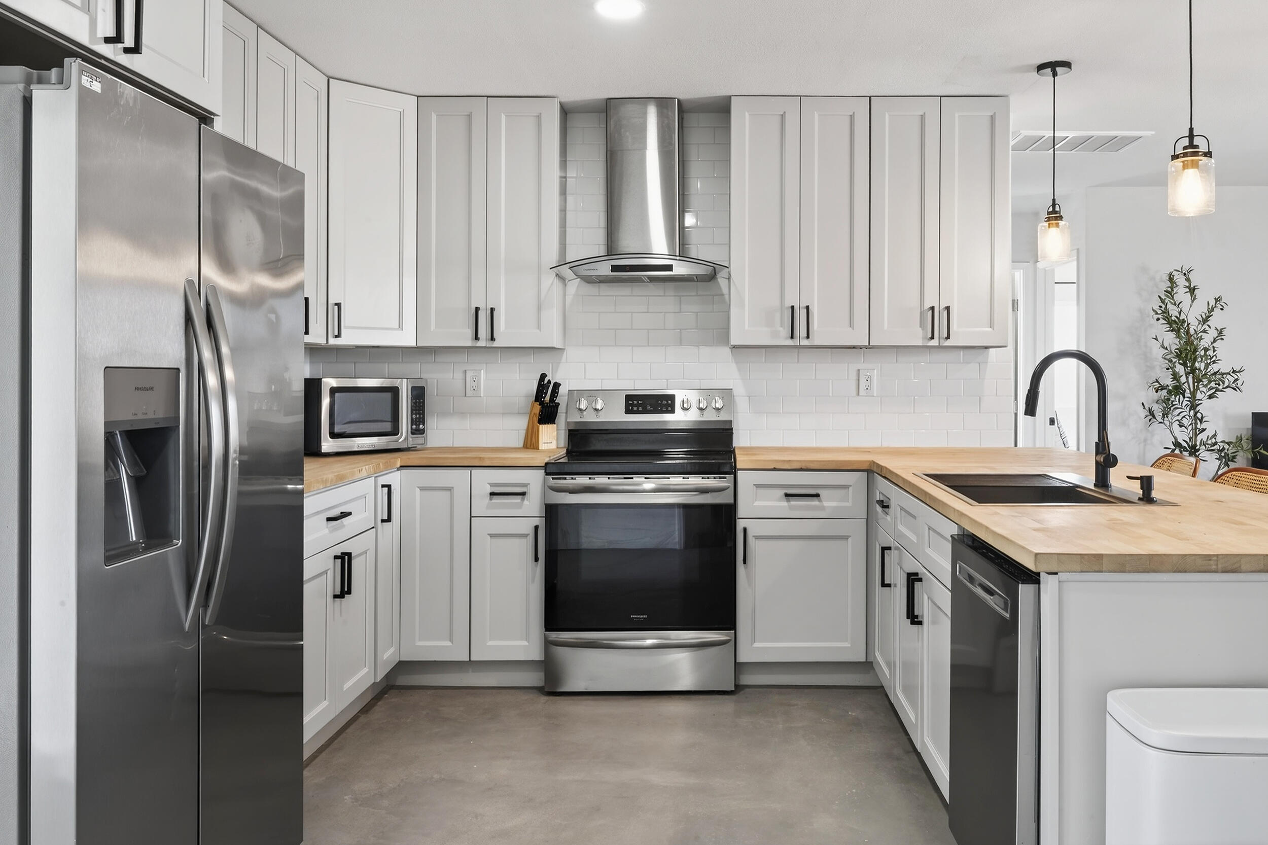 2071 Border Avenue Joshua Tree, CA 92252 - Photo 15 of 50 a kitchen with a sink cabinets and stainless steel appliances