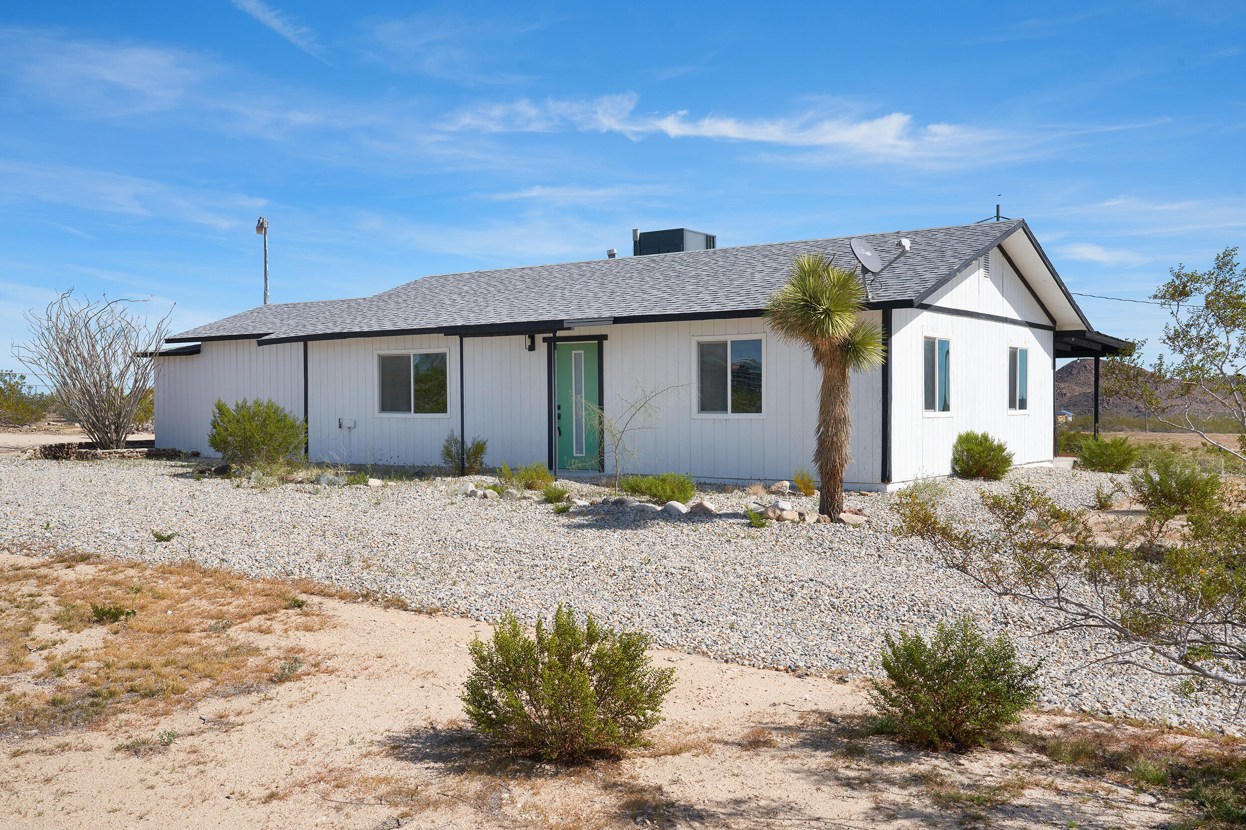 2071 Border Avenue Joshua Tree, CA 92252 - Photo 2 of 50 a front view of house with a garden