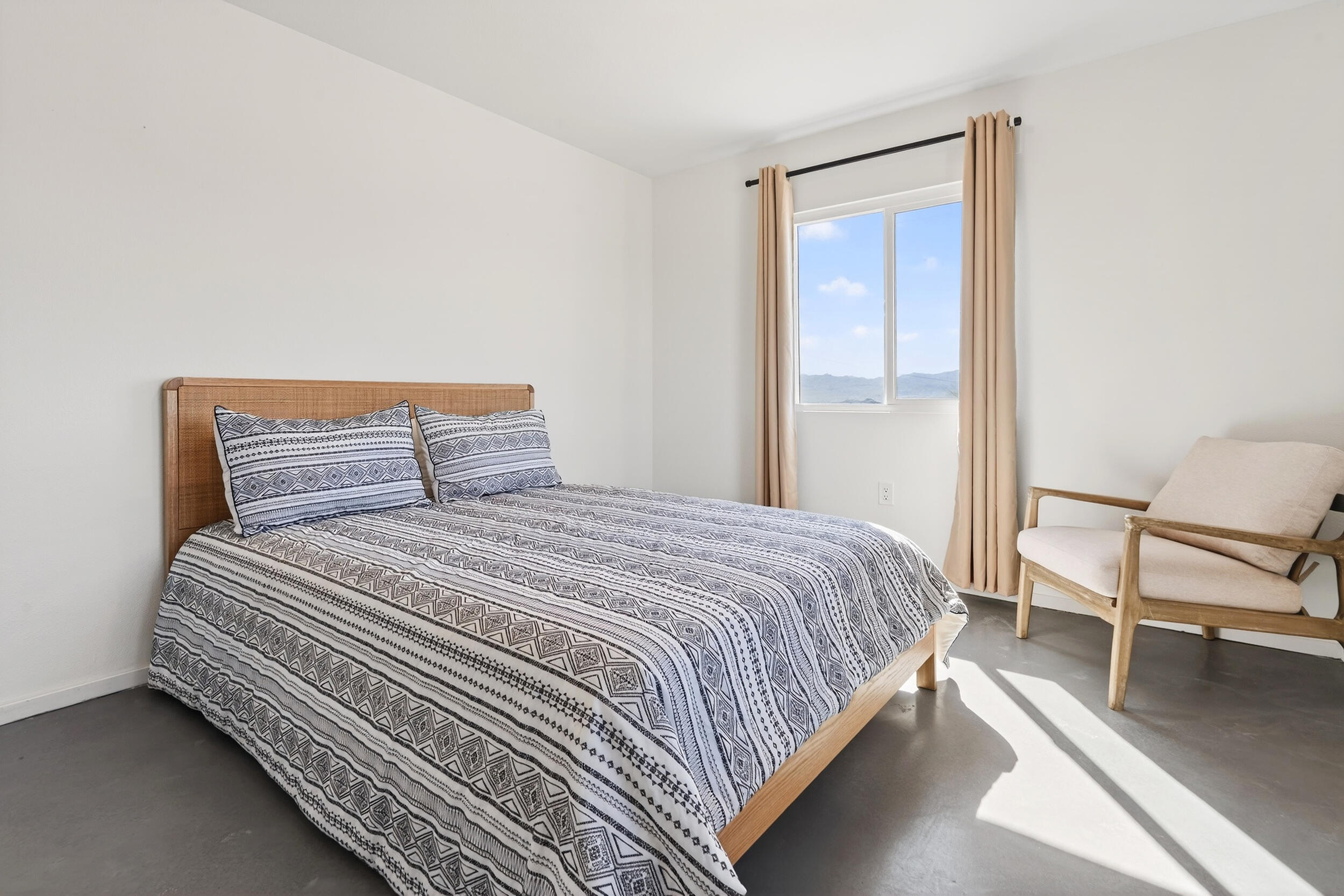 2071 Border Avenue Joshua Tree, CA 92252 - Photo 25 of 50 a bedroom with a bed and chair