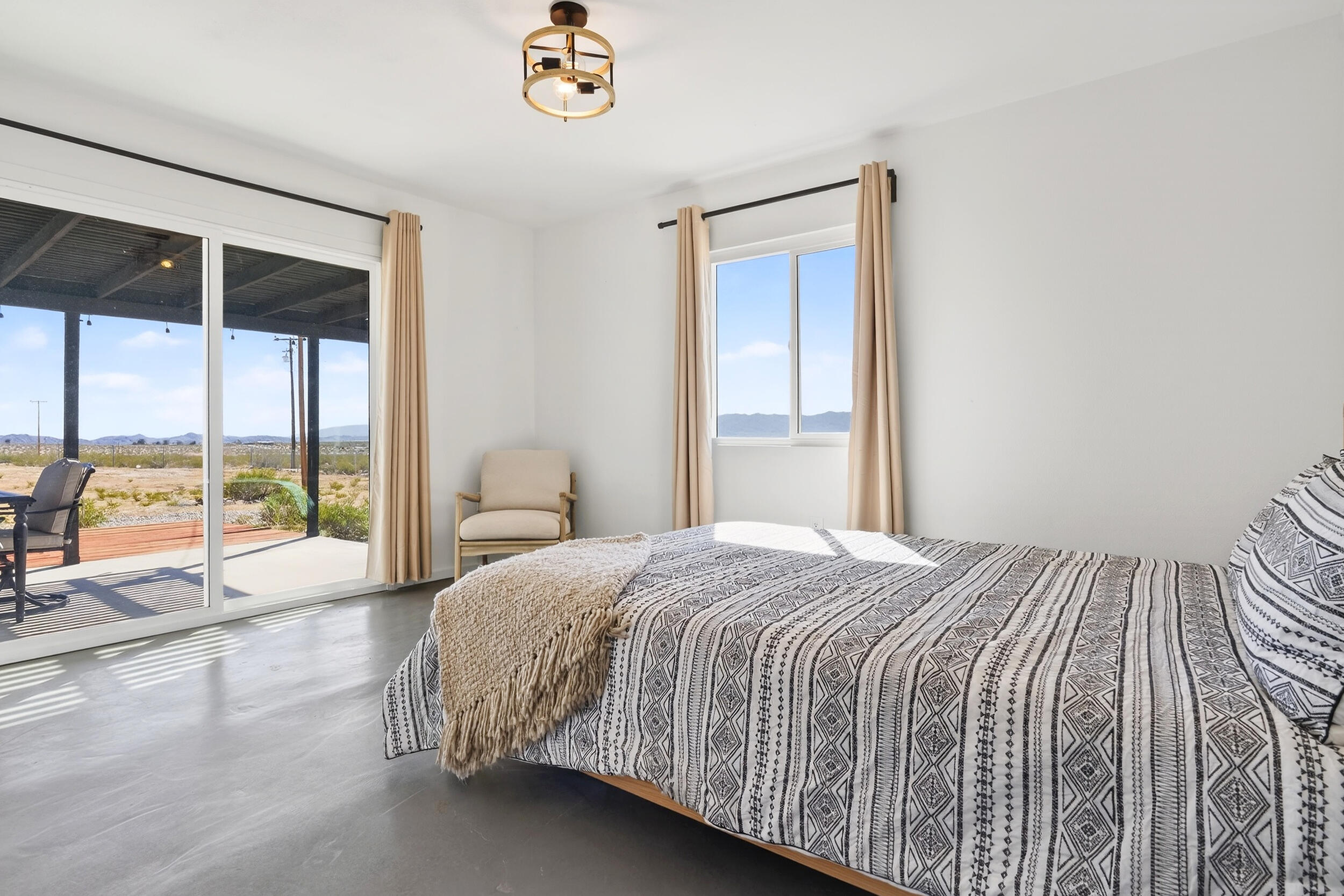 2071 Border Avenue Joshua Tree, CA 92252 - Photo 26 of 50 a bedroom with a large bed and a large window
