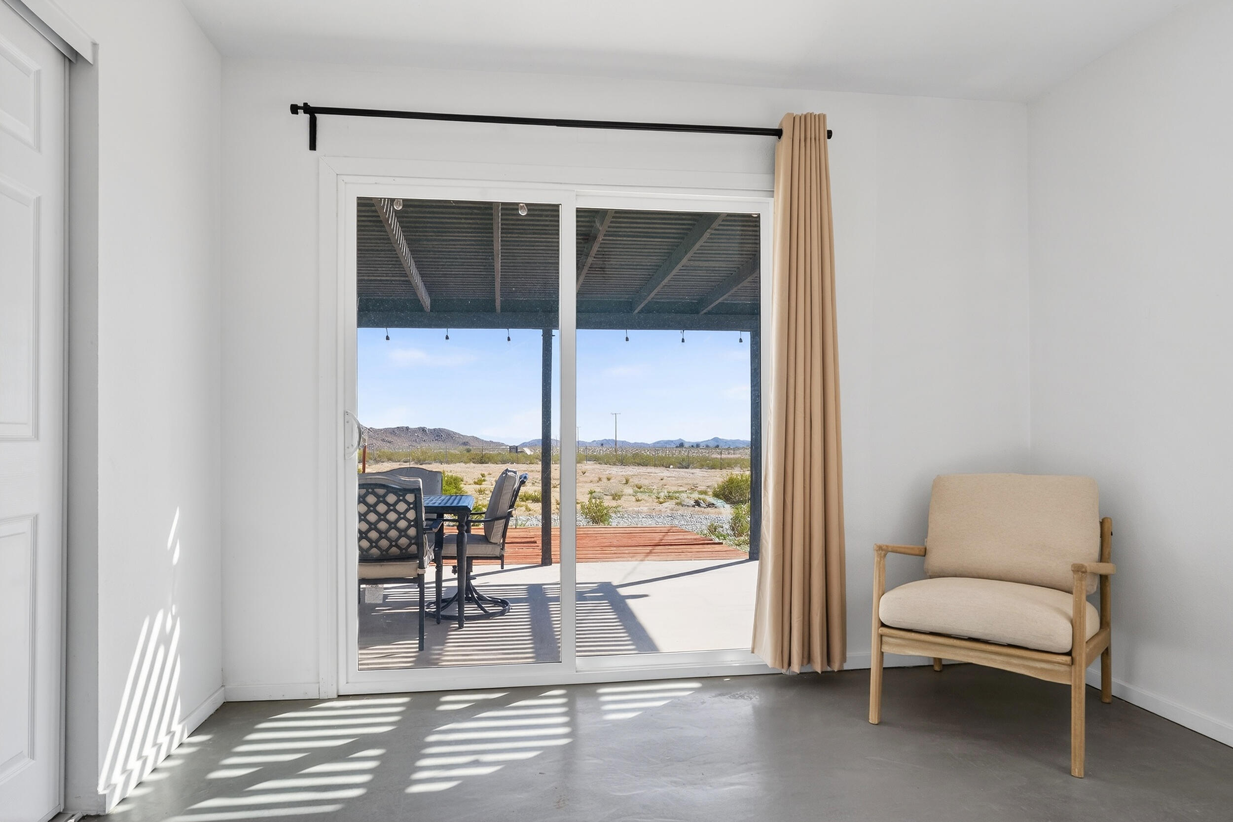 2071 Border Avenue Joshua Tree, CA 92252 - Photo 28 of 50 a living room with furniture a rug and a window
