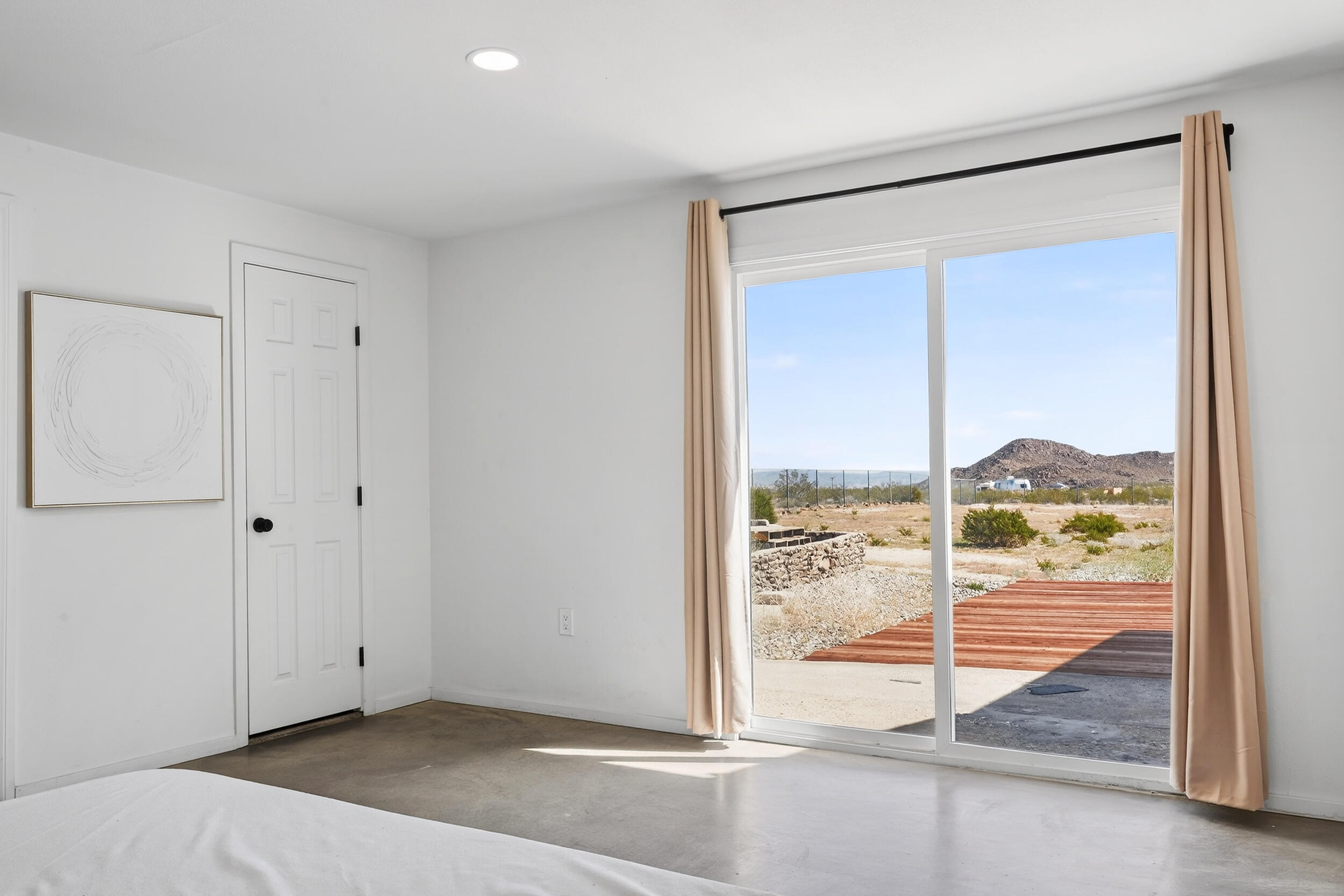 2071 Border Avenue Joshua Tree, CA 92252 - Photo 35 of 50 a view of a room with wooden floor and sliding glass door