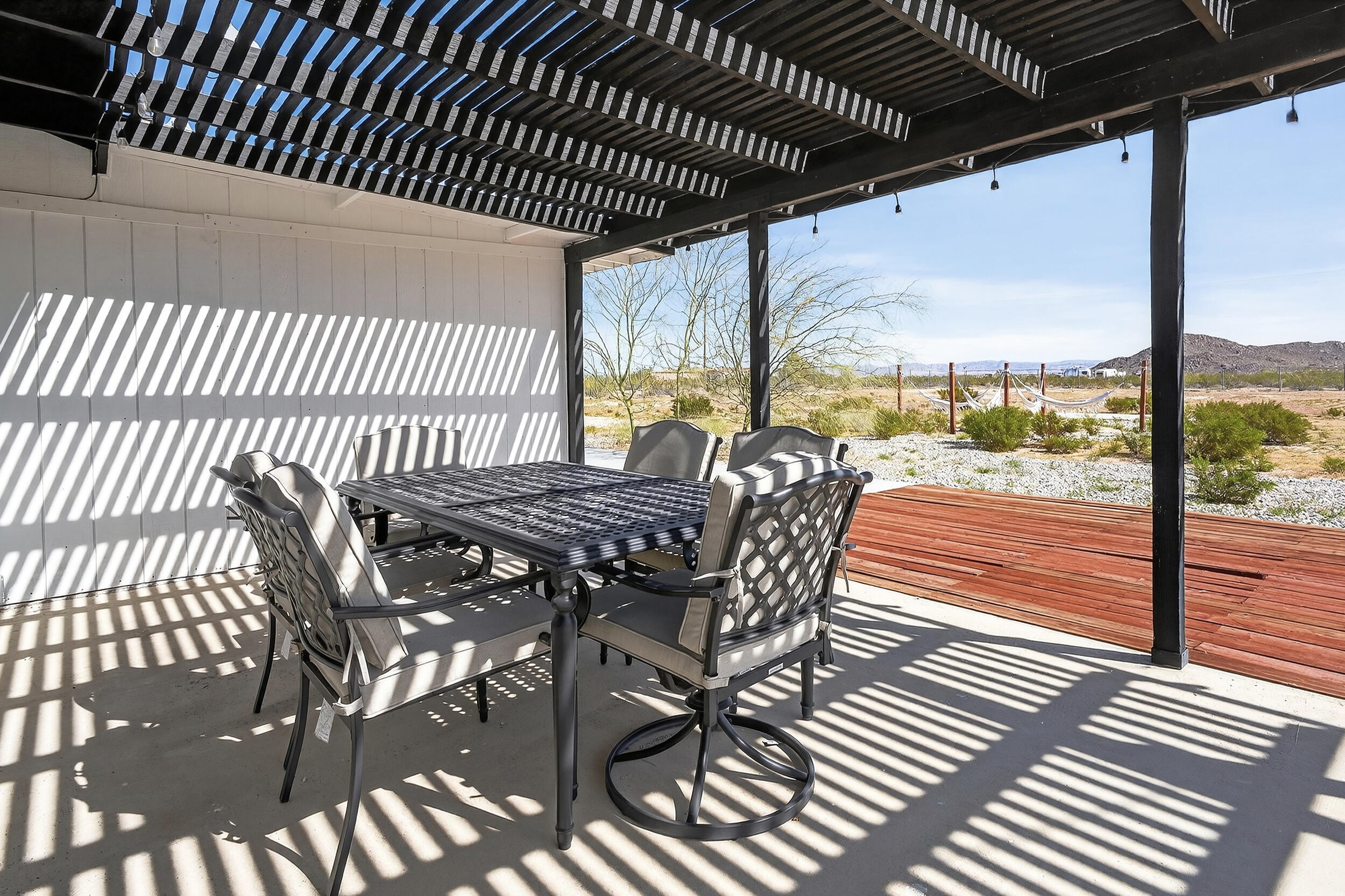 2071 Border Avenue Joshua Tree, CA 92252 - Photo 41 of 50 a view of a patio with a table chairs and wooden floor