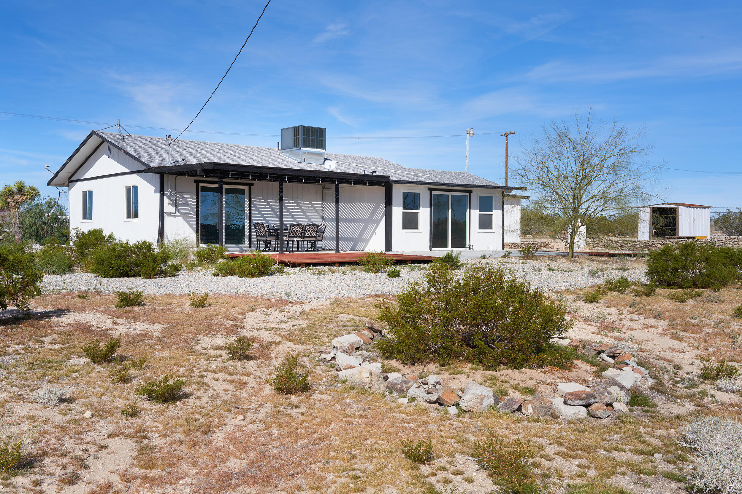 2071 Border Avenue Joshua Tree, CA 92252 - Photo 44 of 50 a front view of a house with a yard