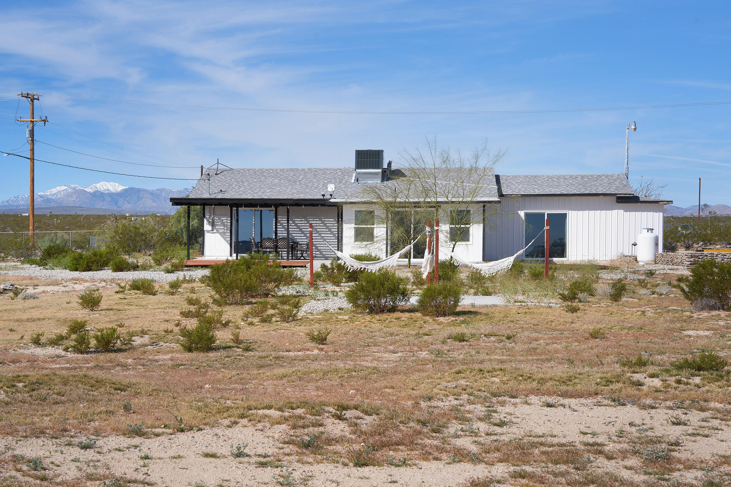 2071 Border Avenue Joshua Tree, CA 92252 - Photo 46 of 50 a front view of a house with a yard