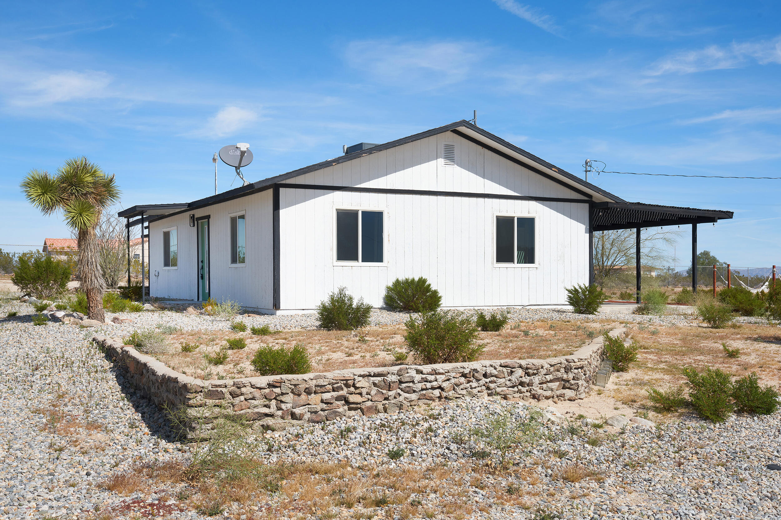 2071 Border Avenue Joshua Tree, CA 92252 - Photo 5 of 50 a front view of a house with a yard