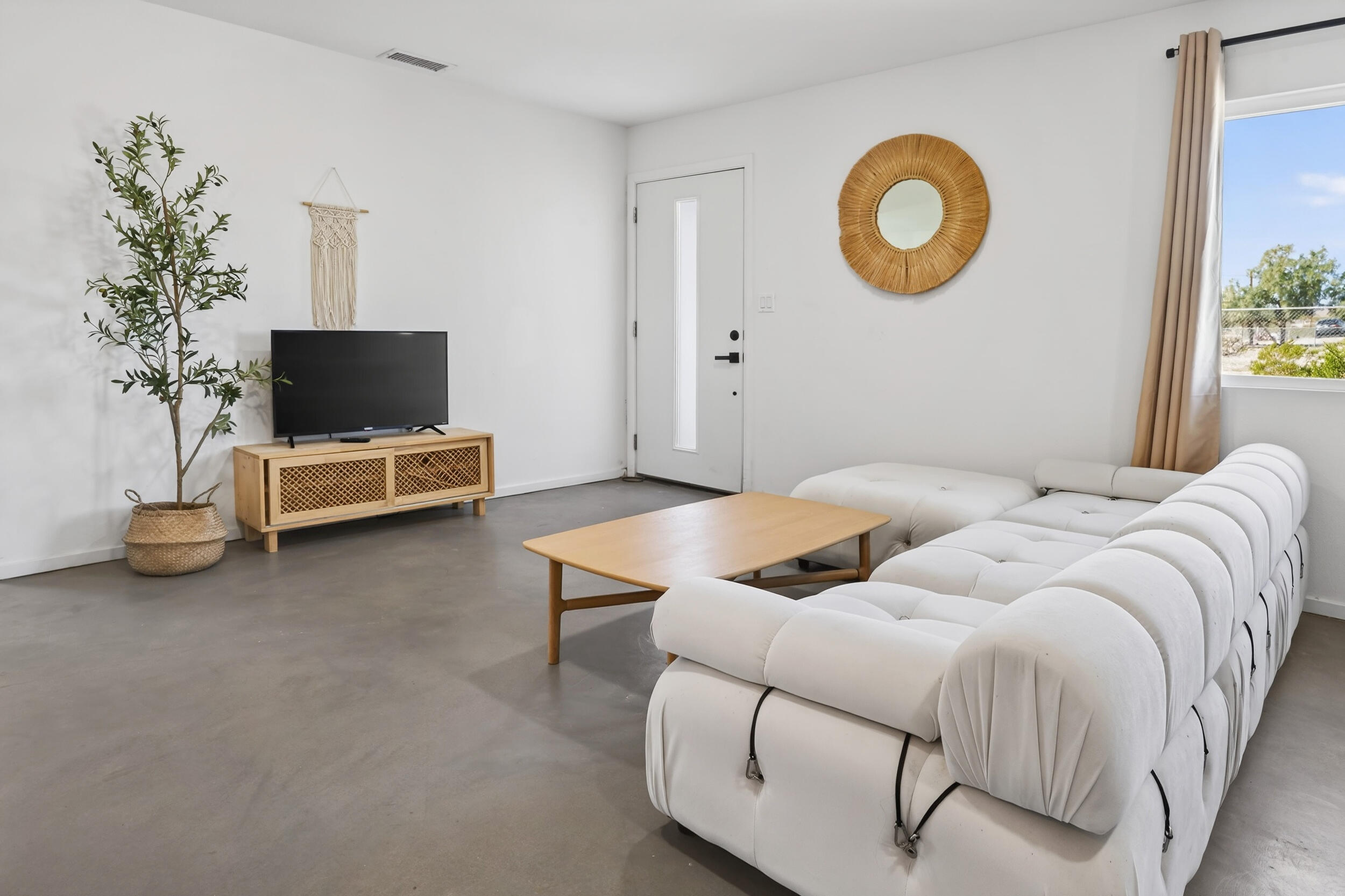 2071 Border Avenue Joshua Tree, CA 92252 - Photo 7 of 50 a bedroom with a bed and a potted plant