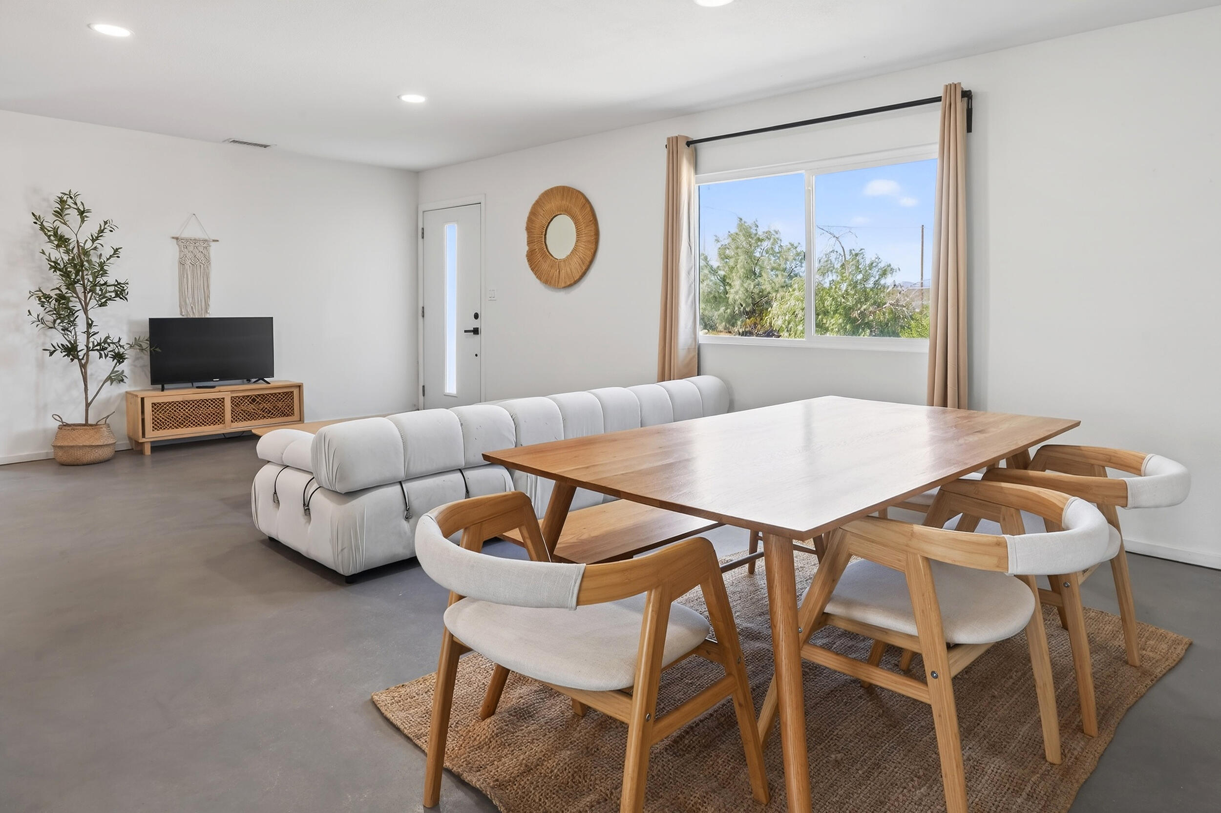2071 Border Avenue Joshua Tree, CA 92252 - Photo 9 of 50 a view of a dining room with furniture and a large window