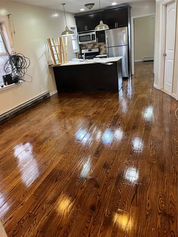 a view of kitchen sink and dishwasher with wooden floor
