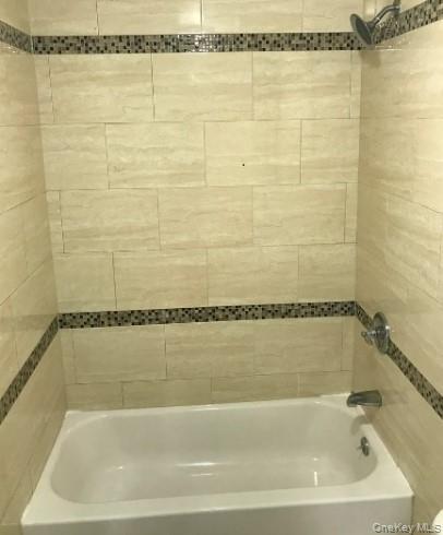 168-28 106th Avenue, Unit 1 Queens, NY 11433 - Photo 5 of 13 a bathroom with a shower and a bath tub