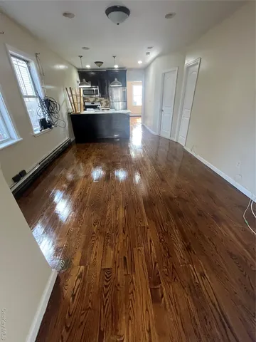 a view of a hallway with wooden floor