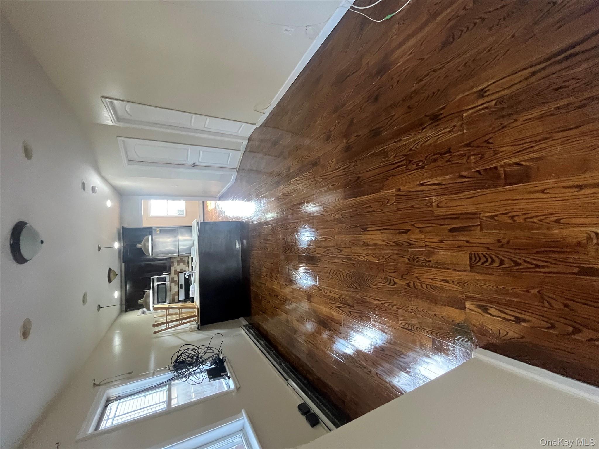168-28 106th Avenue, Unit 1 Queens, NY 11433 - Photo 7 of 13 a view of a hallway with wooden floor