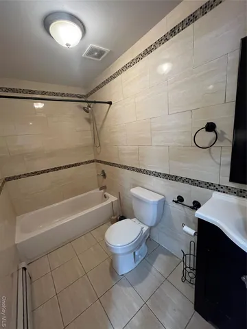 a bathroom with a sink a toilet and a shower
