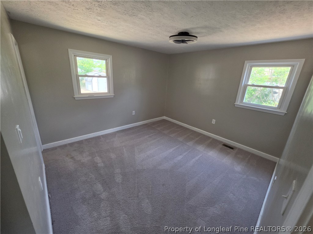 220 Cecil Avenue Spring Lake, NC 28390 - Photo 11 of 21 an empty room with windows