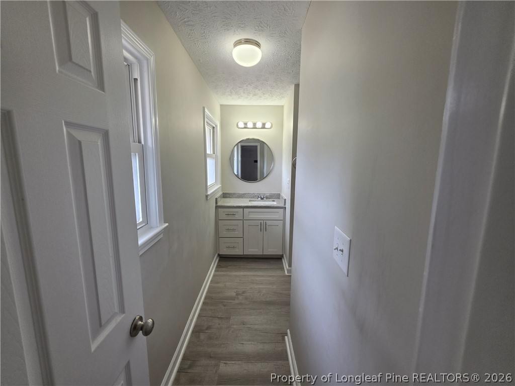 220 Cecil Avenue Spring Lake, NC 28390 - Photo 17 of 21 a bathroom with a sink a toilet and shower