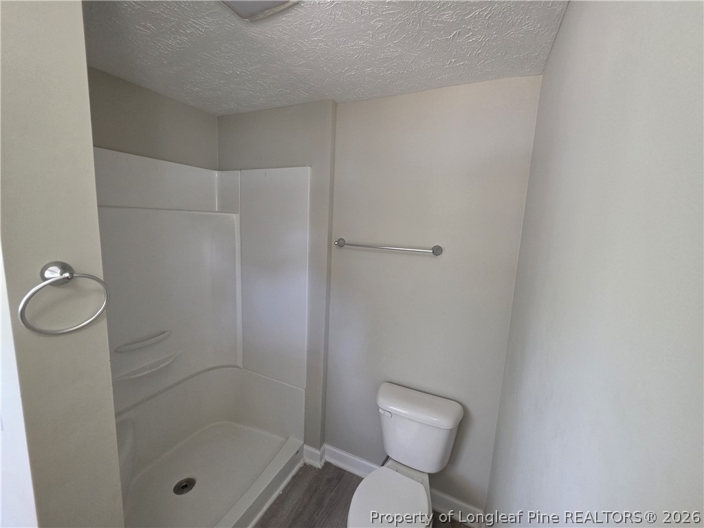 220 Cecil Avenue Spring Lake, NC 28390 - Photo 18 of 21 a bathroom with a shower a toilet and a sink