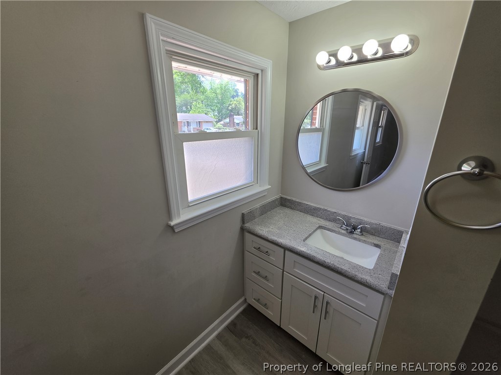 220 Cecil Avenue Spring Lake, NC 28390 - Photo 19 of 21 a bathroom with a sink and a mirror