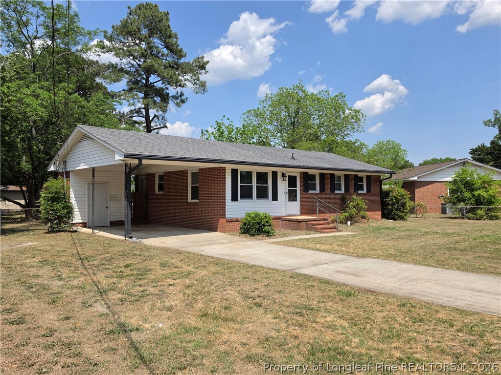 220 Cecil Avenue Spring Lake, NC 28390 - Photo 2 of 21 a front view of a house with a yard and garage