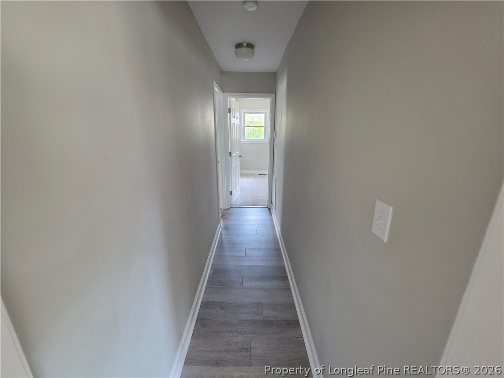 220 Cecil Avenue Spring Lake, NC 28390 - Photo 10 of 21 a view of a hallway with wooden floor