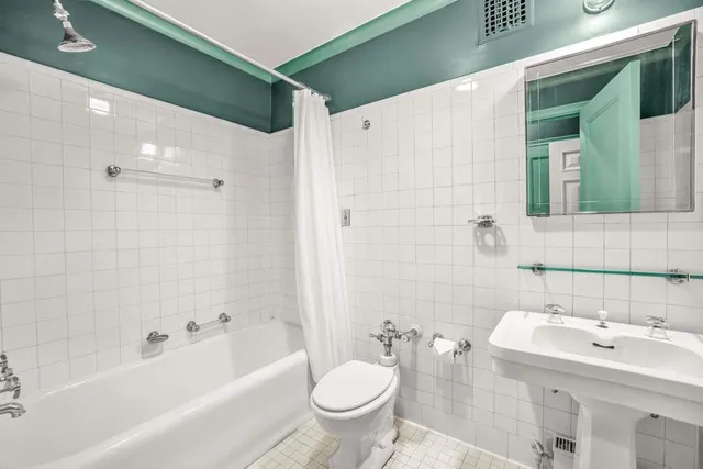 a bedroom with furniture and a large window