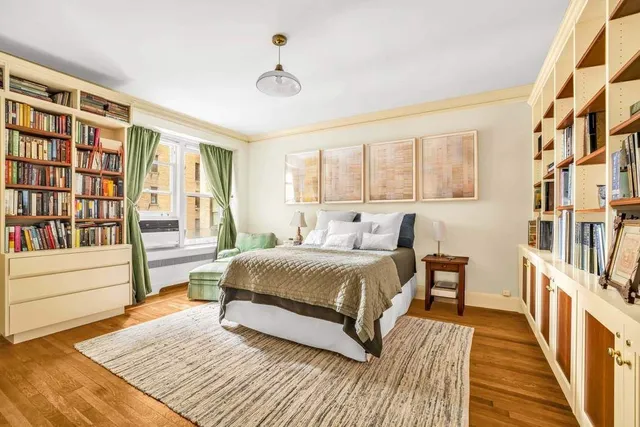 a bedroom with a large bed and a window