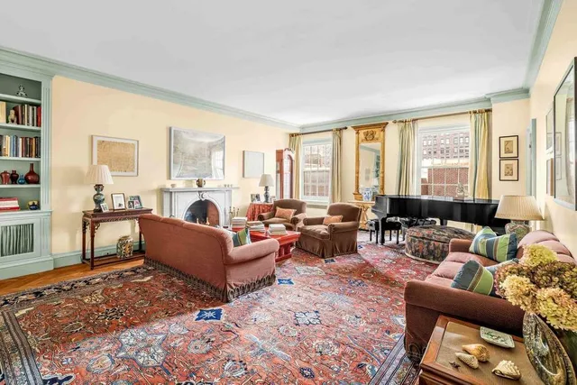 a living room with furniture a rug and a lamp