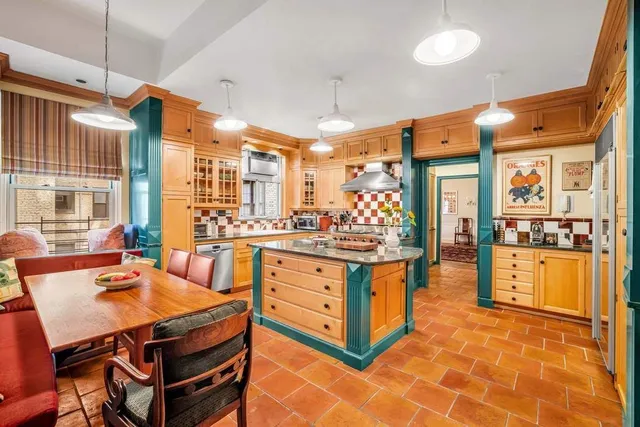 a dining room with furniture a chandelier and wooden floor