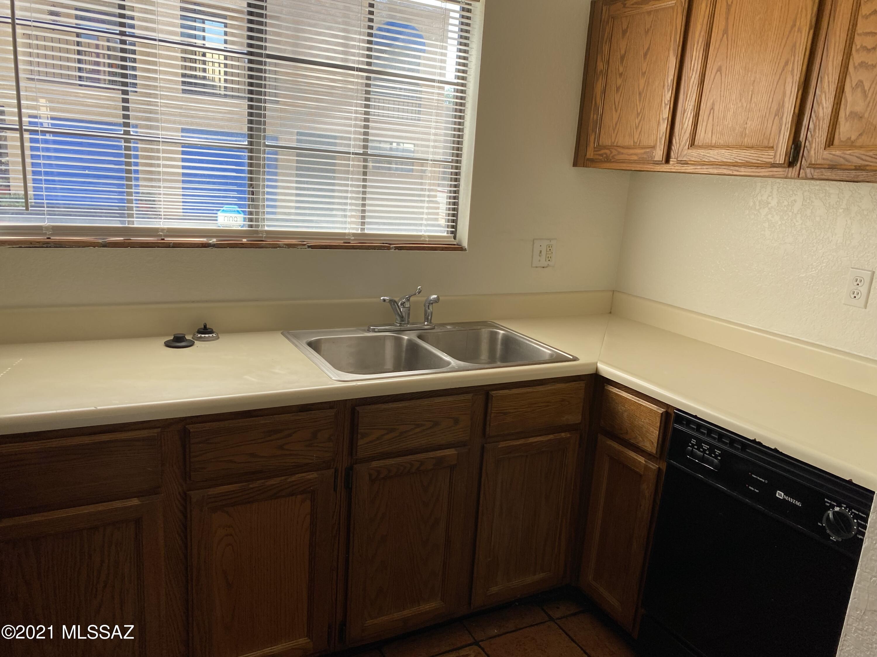 210 East Pastime Road Tucson, AZ 85705 - Photo 14 of 29 a kitchen with a sink and cabinets