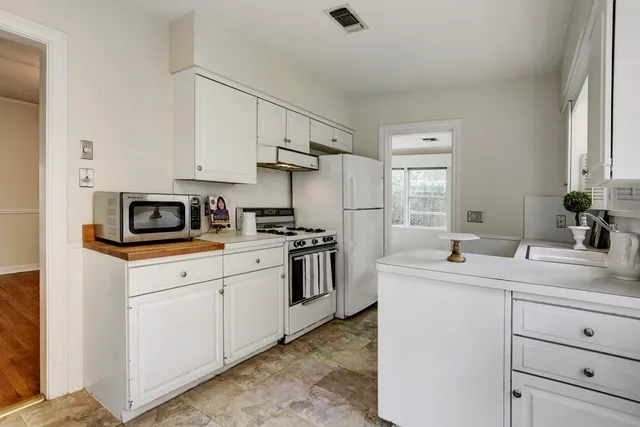 a kitchen with appliances cabinets and a sink