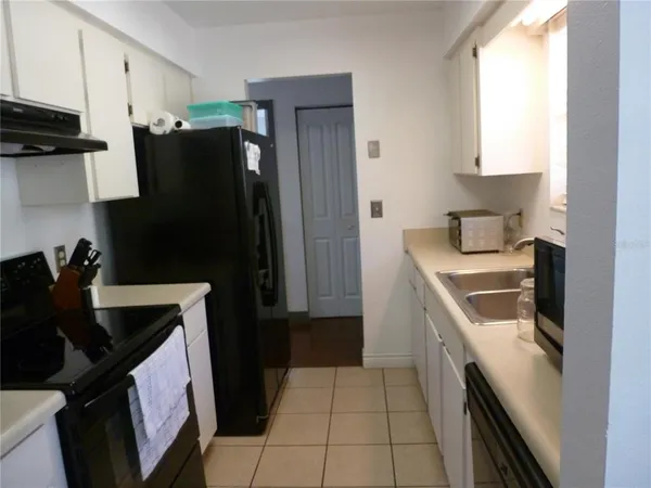 a kitchen with a sink a refrigerator and window