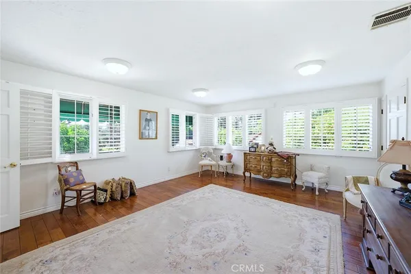 a bedroom with furniture and a large window