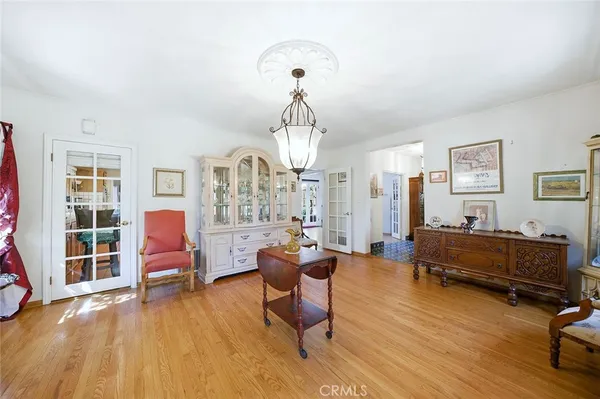 a living room with furniture piano and a chandelier