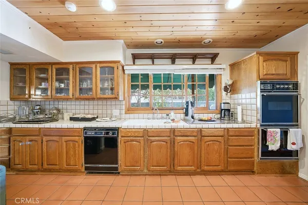 a kitchen with a stove sink and cabinets